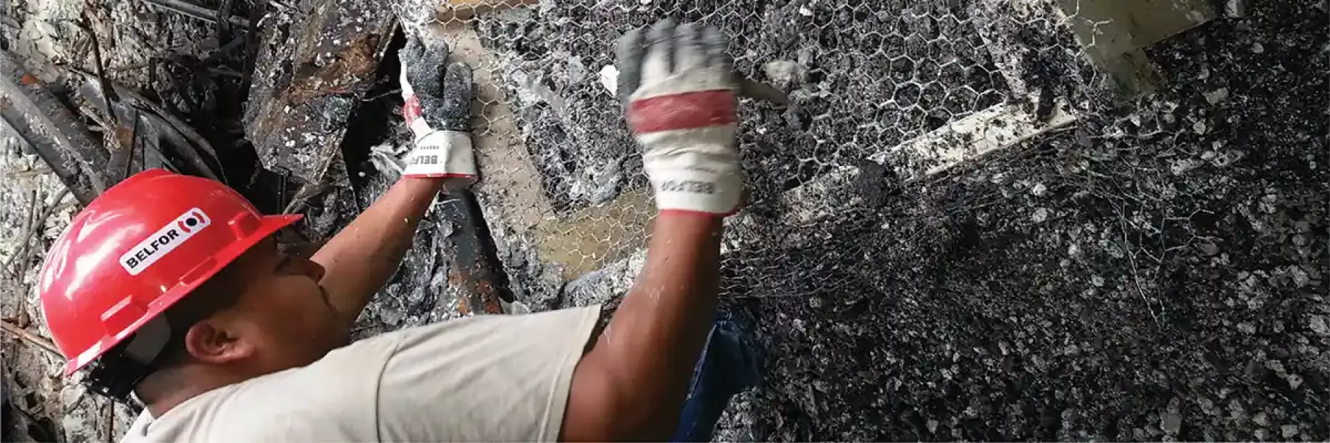 BELFOR technician sifting through fire damage